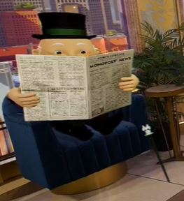 Monopoly Man reading a newspaper